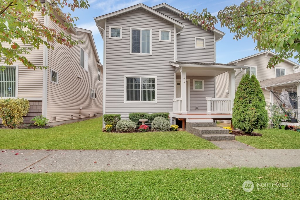 4010 East R Street Tacoma, WA 98404 - Photo 1 of 28 a front view of a house with a yard and garage