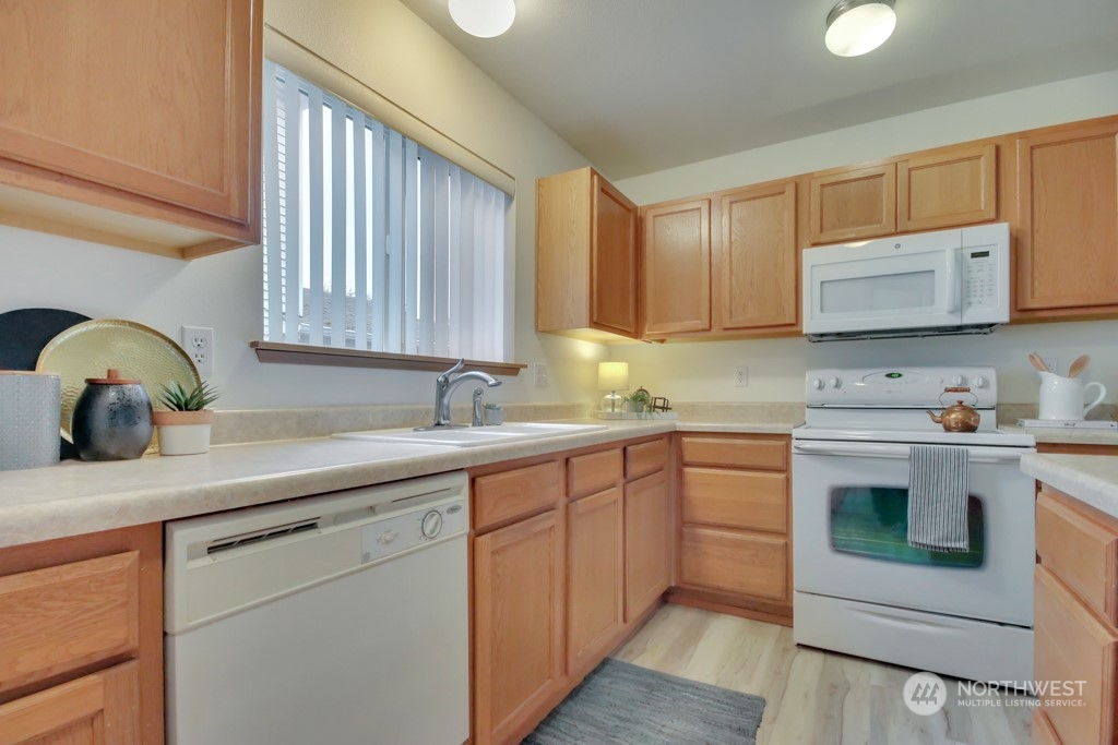 4010 East R Street Tacoma, WA 98404 - Photo 12 of 28 a kitchen with stainless steel appliances granite countertop a sink and a stove