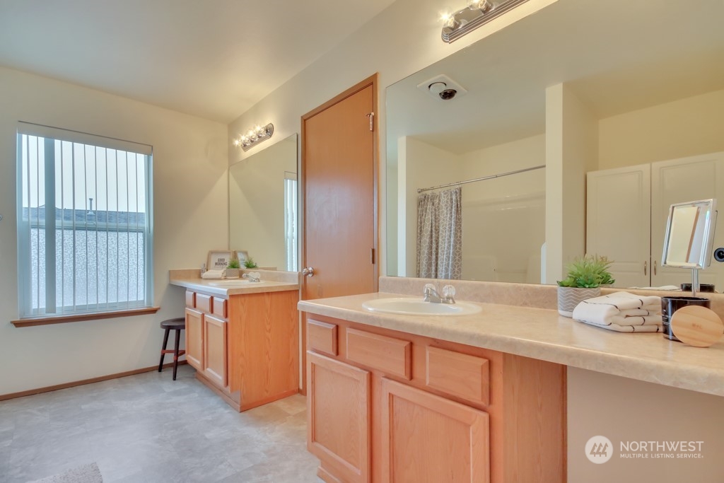 4010 East R Street Tacoma, WA 98404 - Photo 23 of 28 a bathroom with a granite countertop sink and a mirror