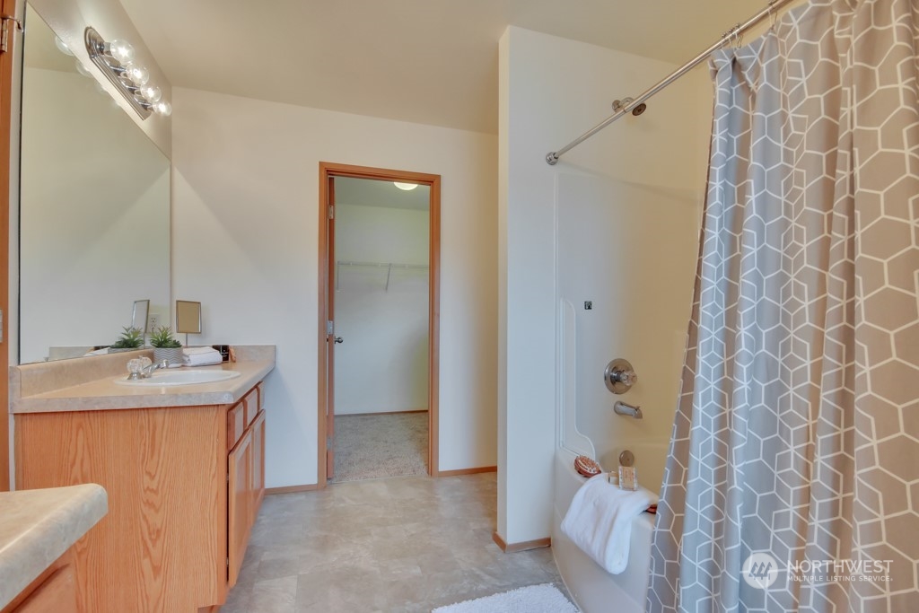 4010 East R Street Tacoma, WA 98404 - Photo 24 of 28 a bathroom with a sink and mirror with toilet