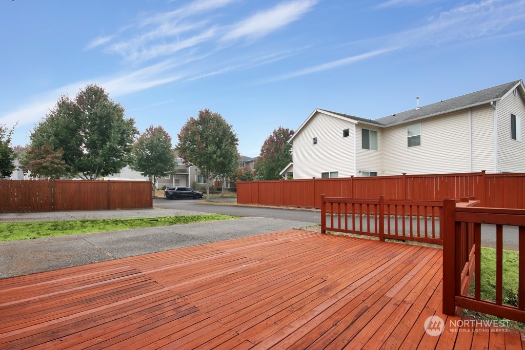 4010 East R Street Tacoma, WA 98404 - Photo 5 of 28 a terrace of a house with wooden floor and fence