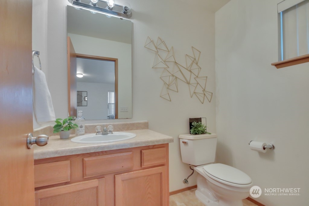 4010 East R Street Tacoma, WA 98404 - Photo 8 of 28 a bathroom with a sink vanity mirror and toilet