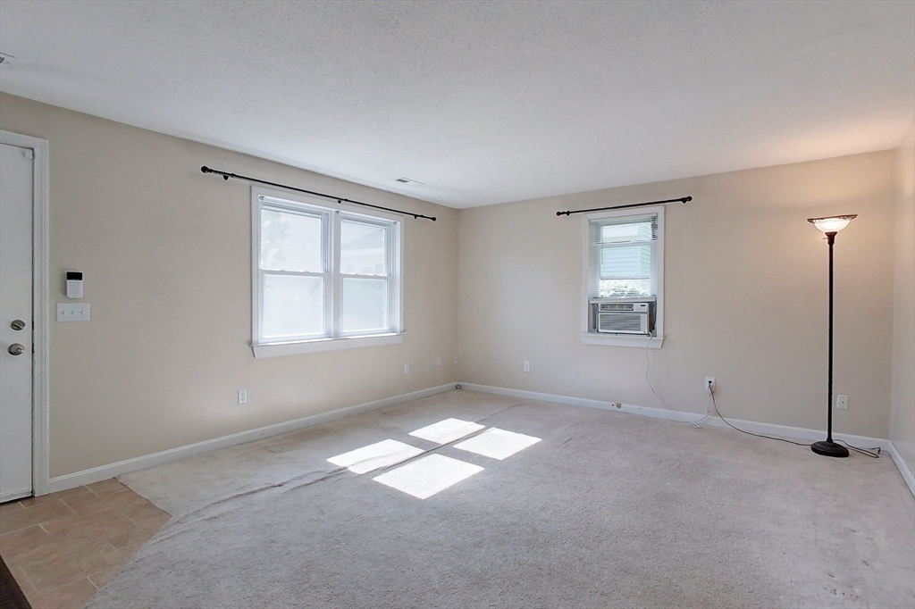 103 Main Street, Unit 10 Pepperell, MA 01463 - Photo 6 of 22 an empty room with windows