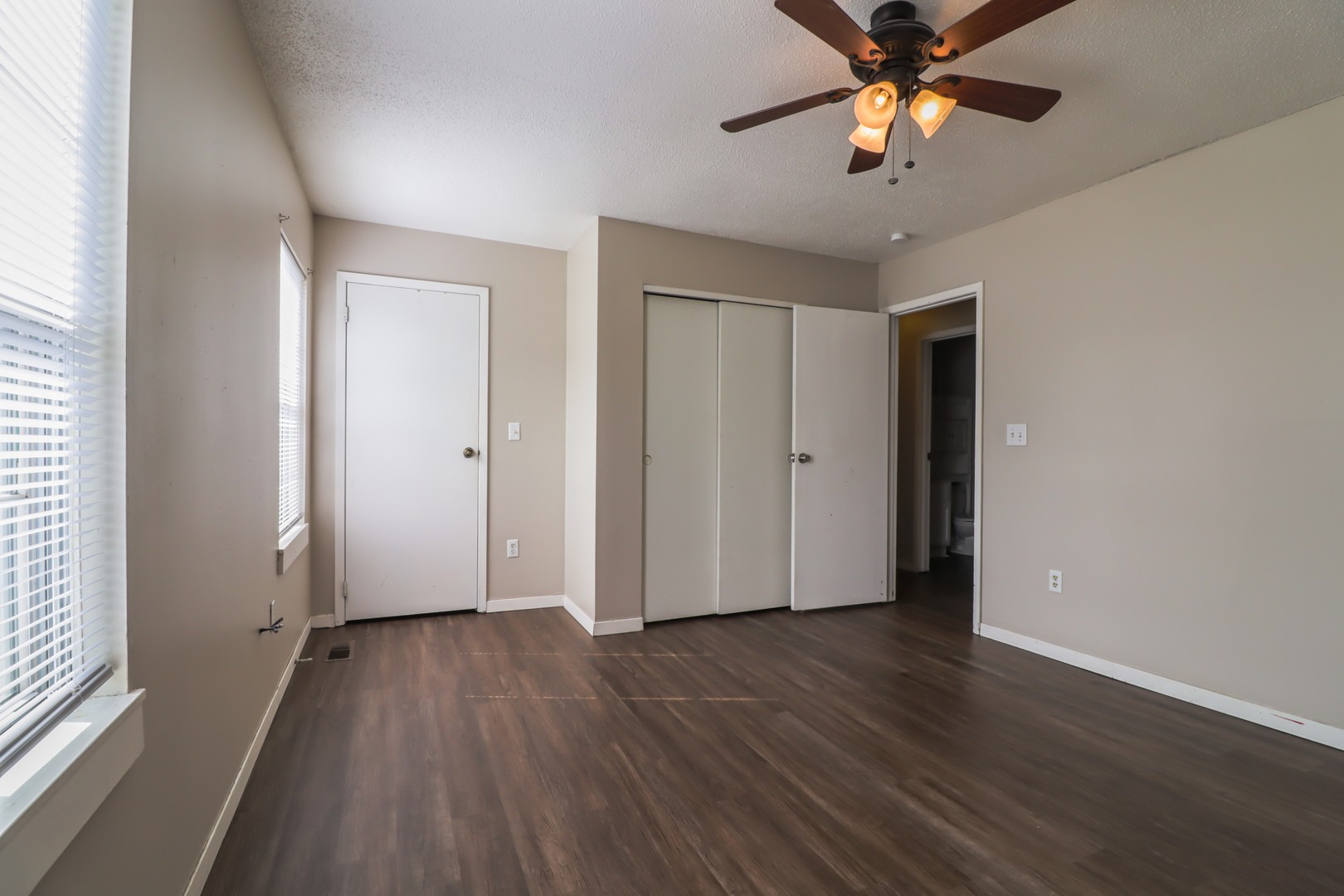 2908 West John Street, Unit B Champaign, IL 61821 - Photo 12 of 16 an empty room with wooden floor and windows