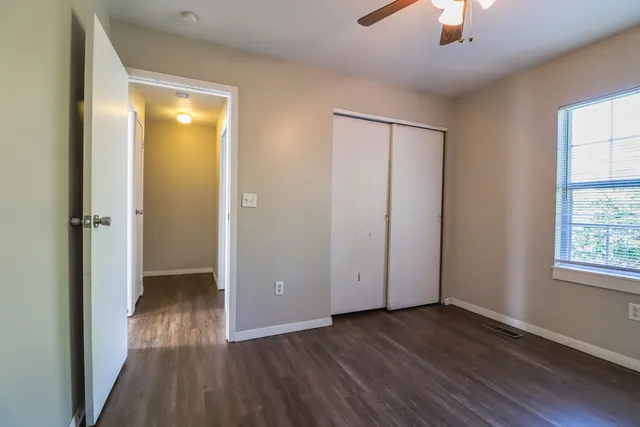 wooden floor in an empty room with a window