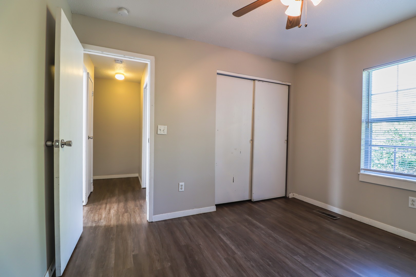 2908 West John Street, Unit B Champaign, IL 61821 - Photo 14 of 16 wooden floor in an empty room with a window