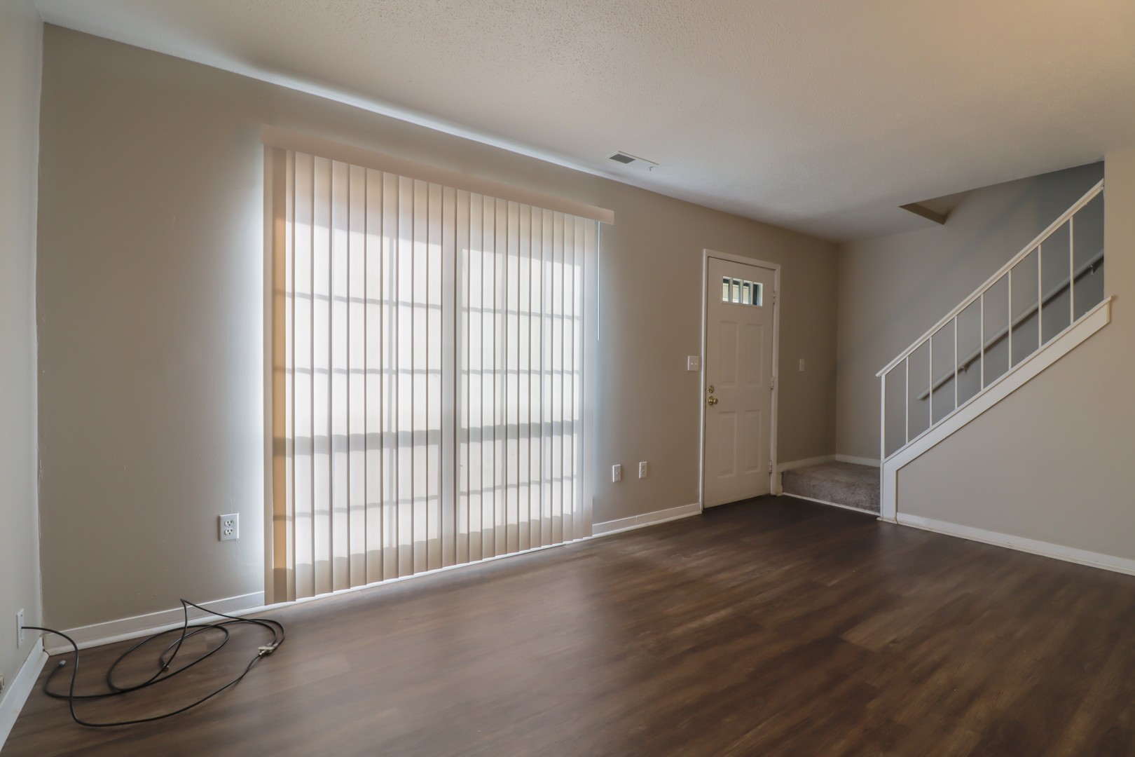 2908 West John Street, Unit B Champaign, IL 61821 - Photo 5 of 16 a view of an empty room with wooden floor and a window