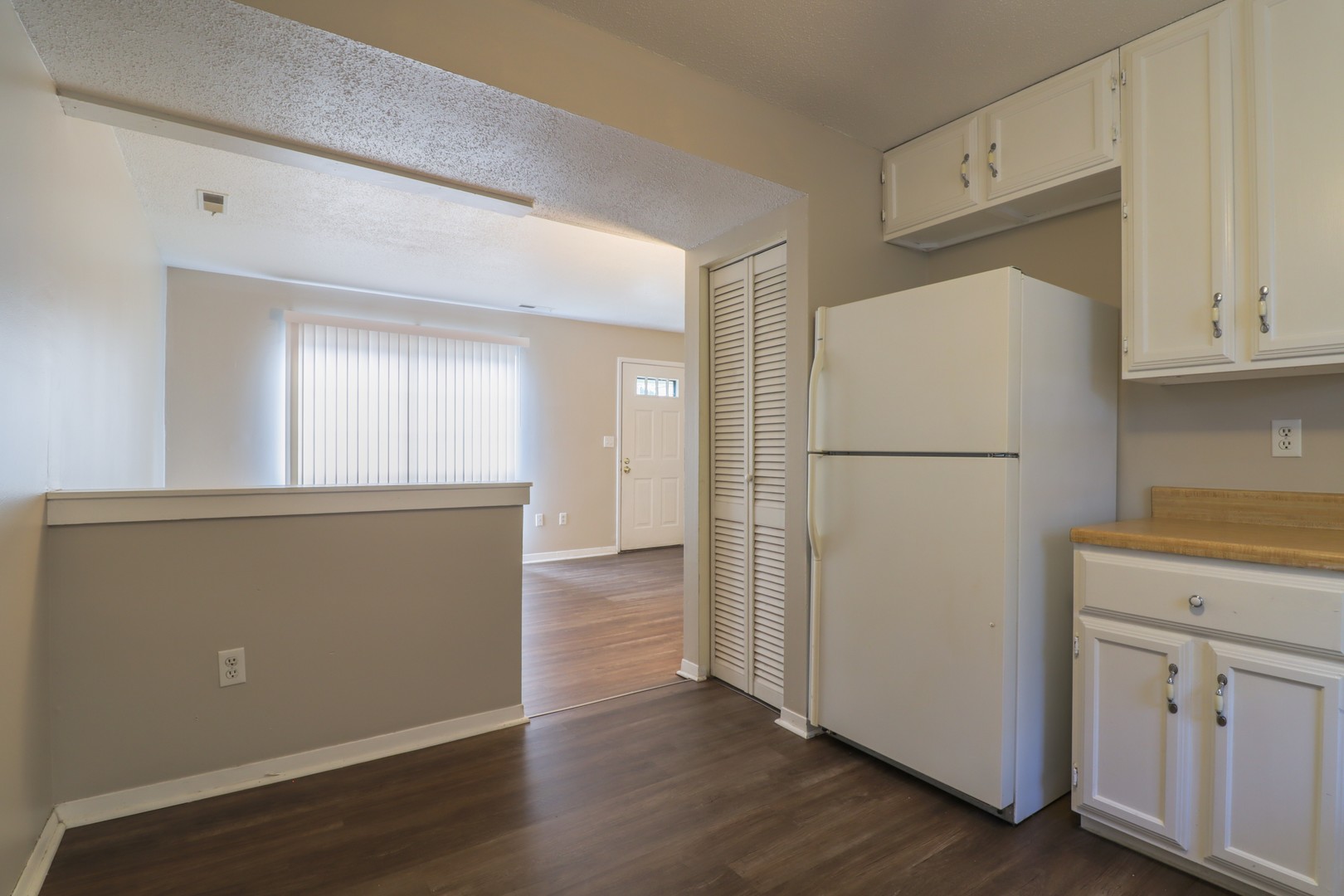 2908 West John Street, Unit B Champaign, IL 61821 - Photo 7 of 16 a view of a kitchen with refrigerator and wooden floor