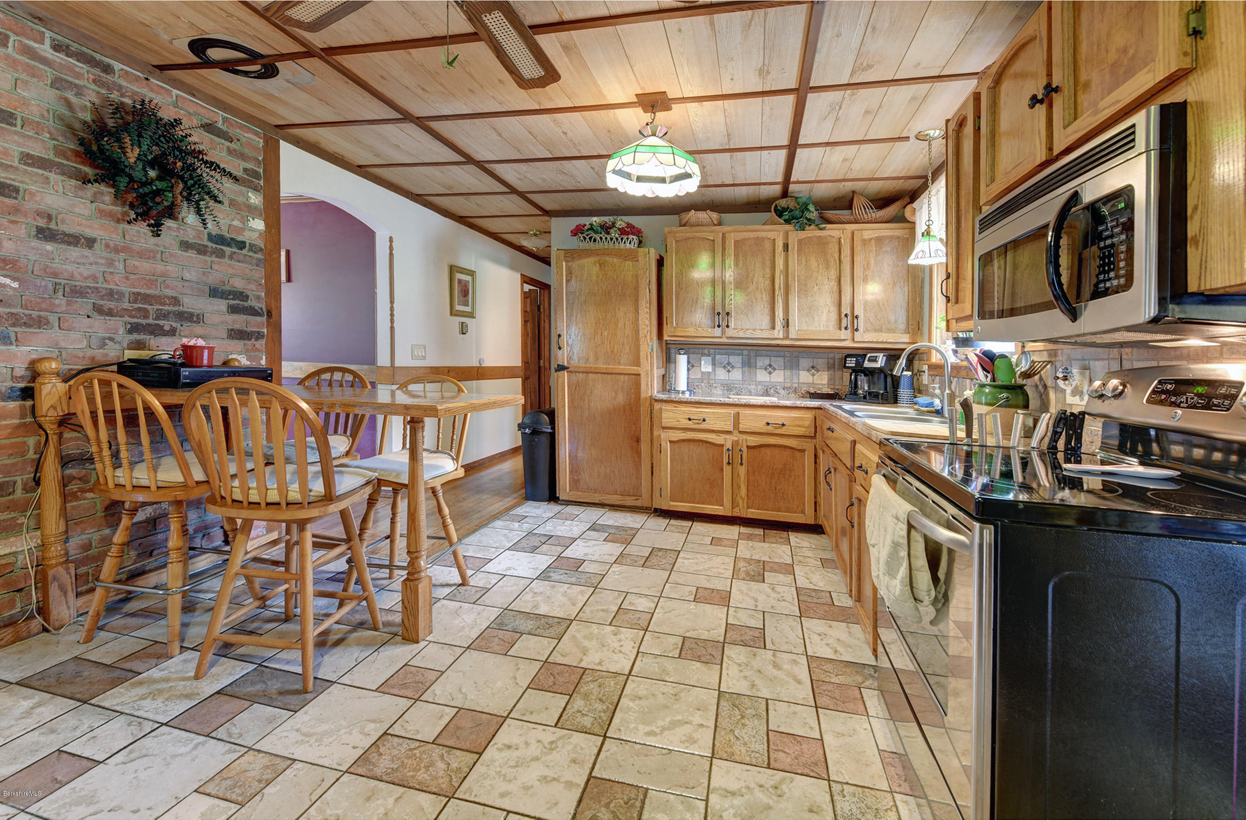 373 Haskins Road Savoy, MA 01256 - Photo 13 of 34 a kitchen with stainless steel appliances a sink a stove top oven a counter space and cabinets