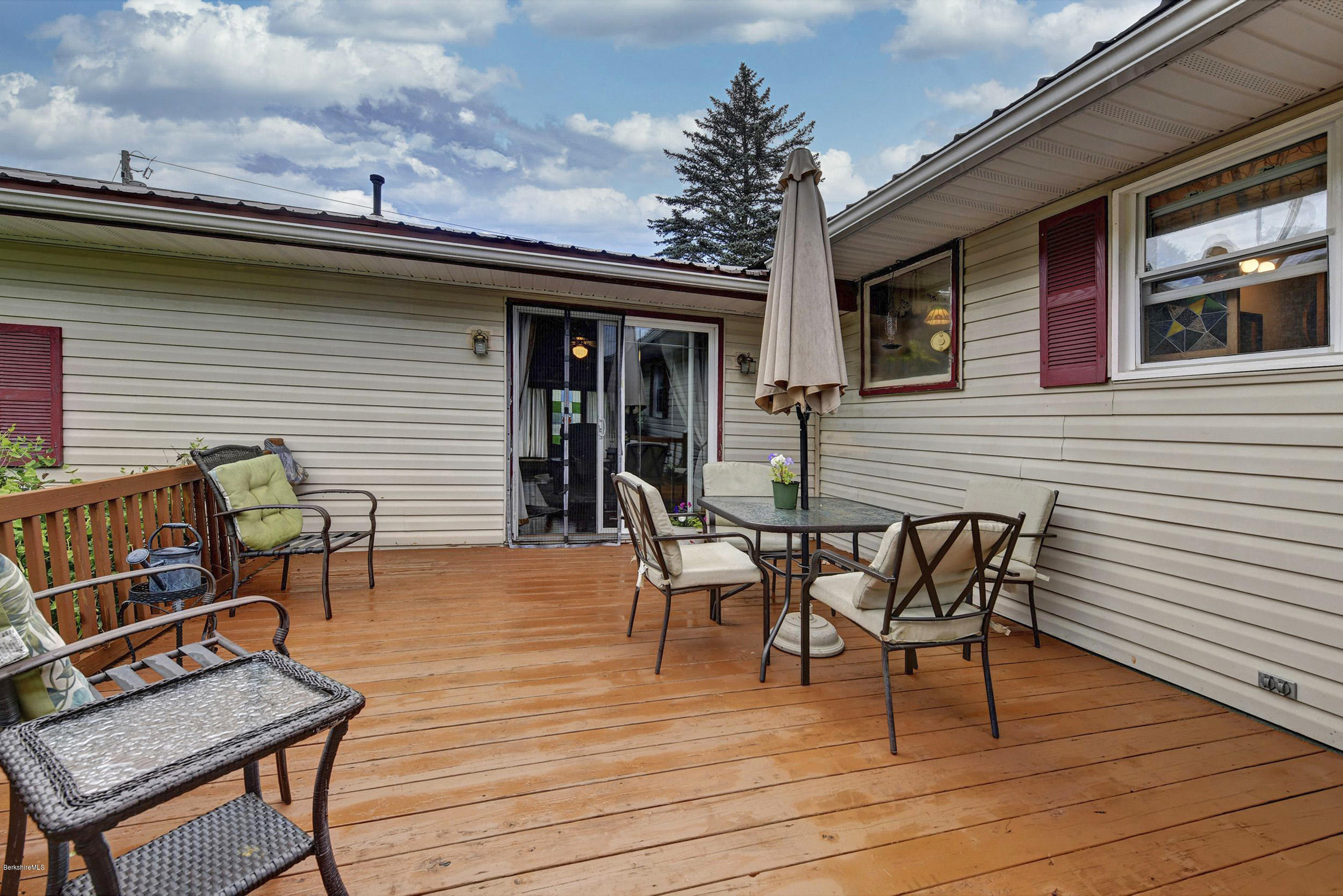 373 Haskins Road Savoy, MA 01256 - Photo 22 of 34 a roof deck with a dining table and chairs with wooden floor