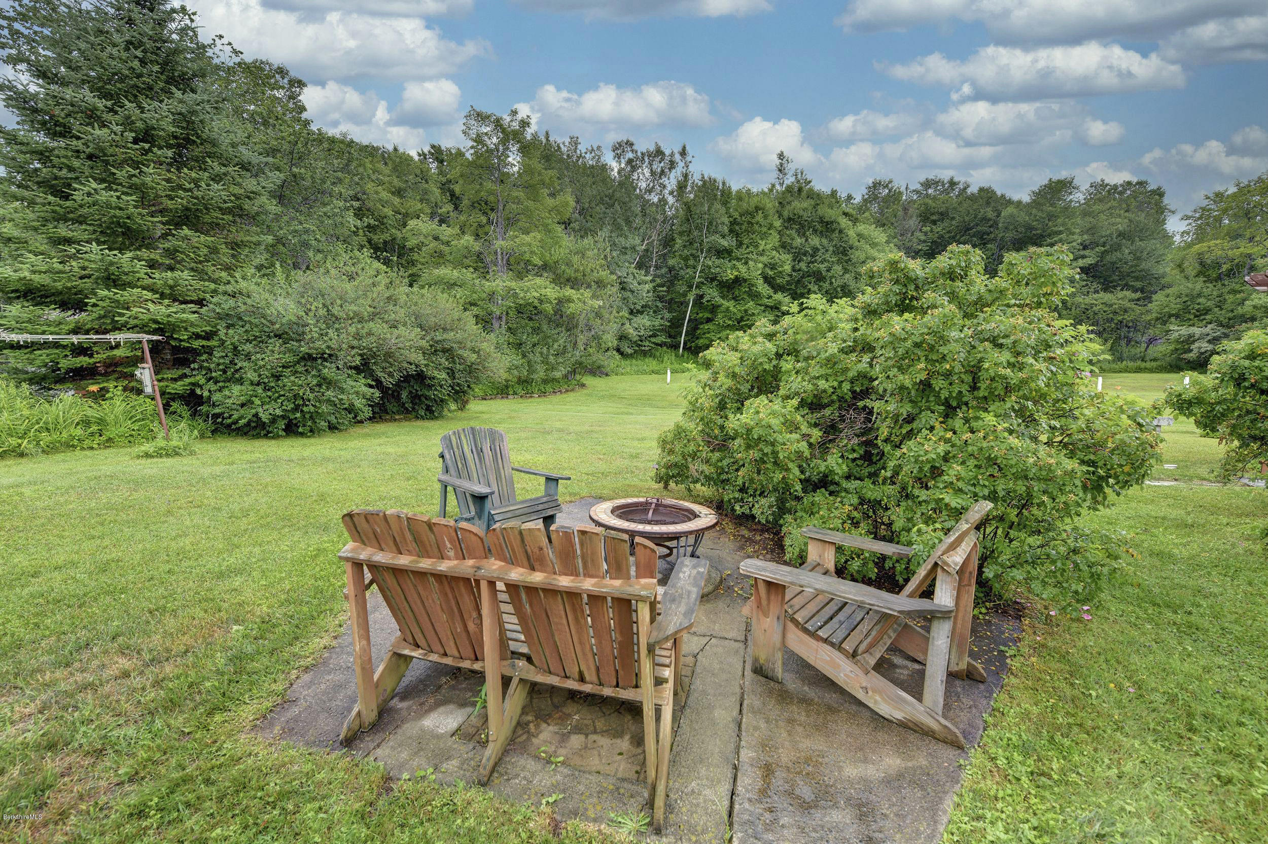 373 Haskins Road Savoy, MA 01256 - Photo 30 of 34 a view of a chairs and table in backyard of the house