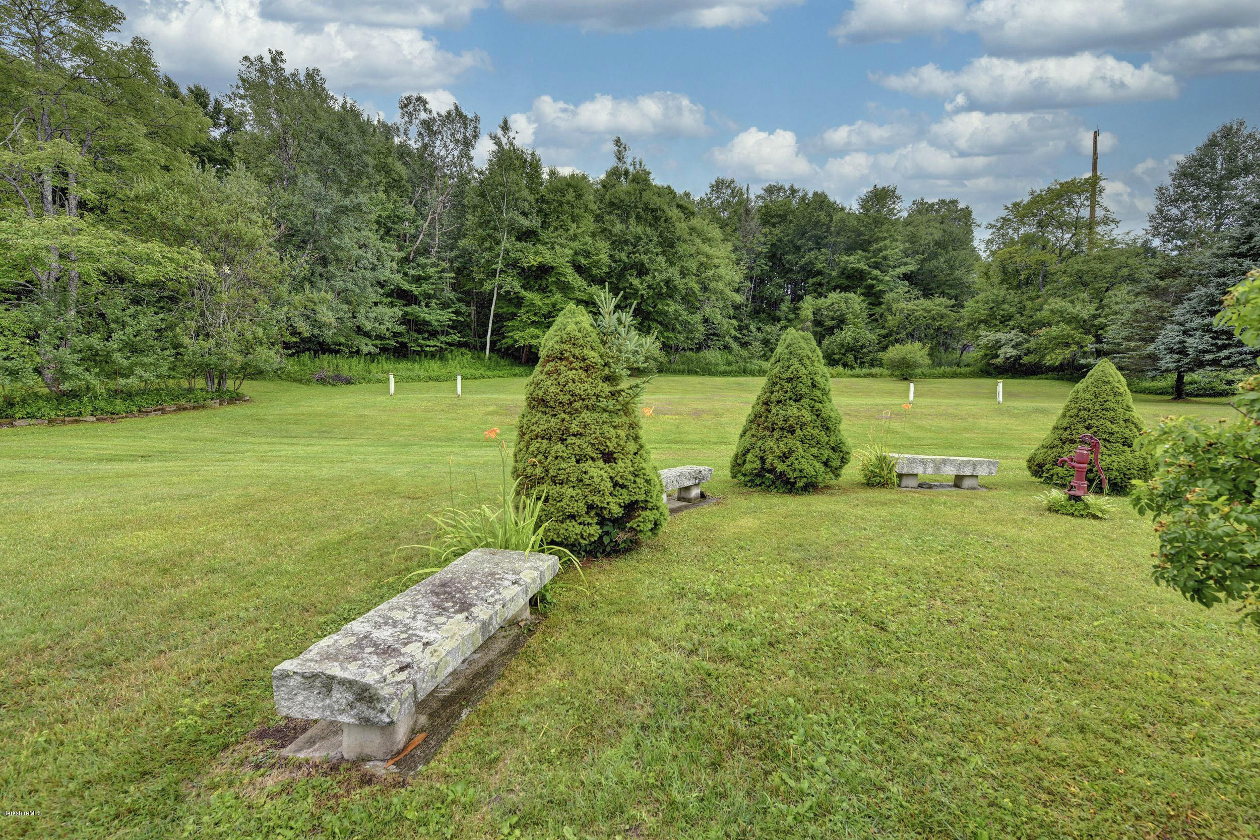 373 Haskins Road Savoy, MA 01256 - Photo 31 of 34 a view of a garden with a bench in the background
