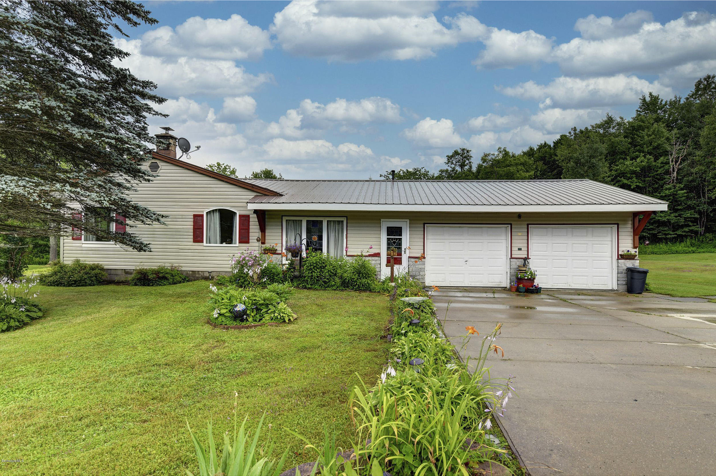 373 Haskins Road Savoy, MA 01256 - Photo 34 of 34 a front view of a house with garden