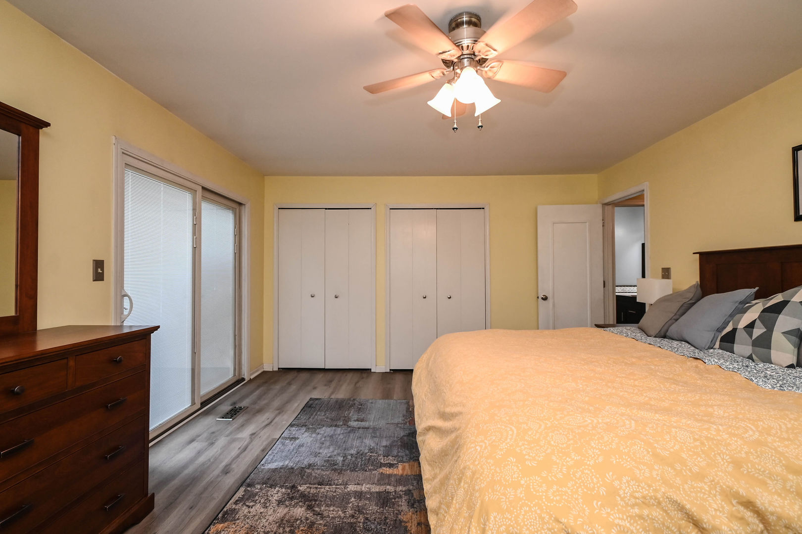 1333 Regency Lane Round Lake, IL 60073 - Photo 18 of 31 a spacious bedroom with a bed and a chandelier