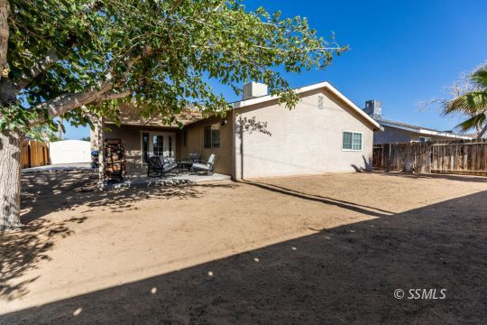 609 South Gemstone Street Ridgecrest, CA 93555 - Photo 33 of 35 a house with trees in front of it