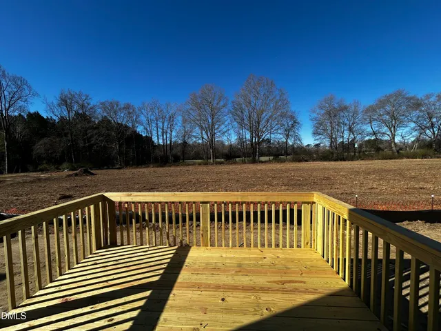a view of wooden deck with a lake view