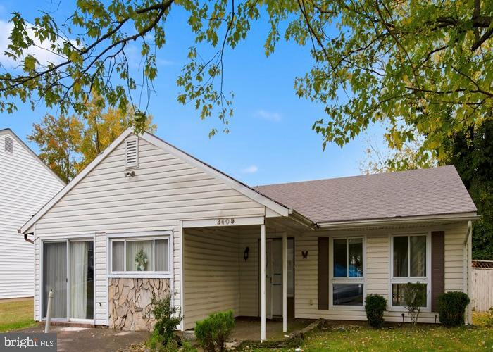 2409 Mary Place Fort Washington, MD 20744 - Photo 2 of 18 a view of a white house with large windows and a tree