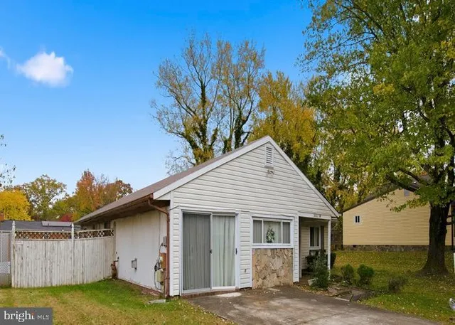 a white house that has a tree in front of it