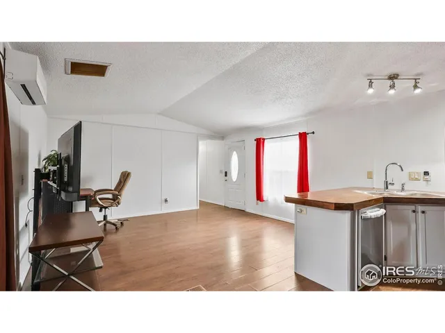 a kitchen with a sink cabinets and wooden floor