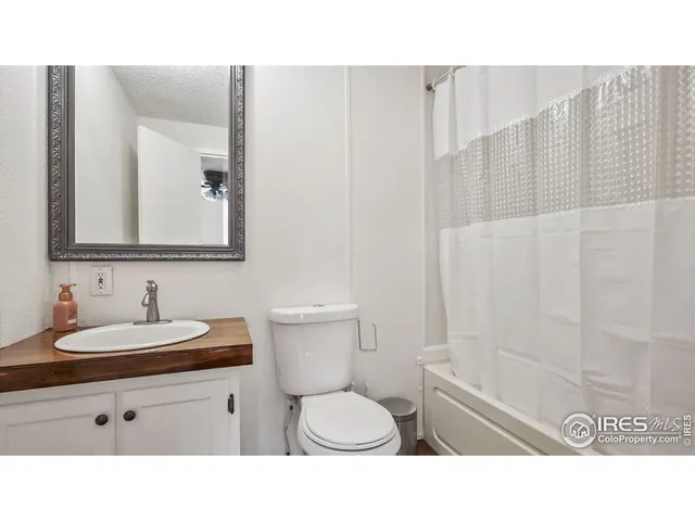 a bathroom with a sink toilet a mirror and shower