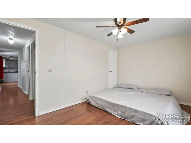 a room with a bed and a ceiling fan