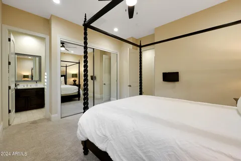 a bedroom with a bed and a television