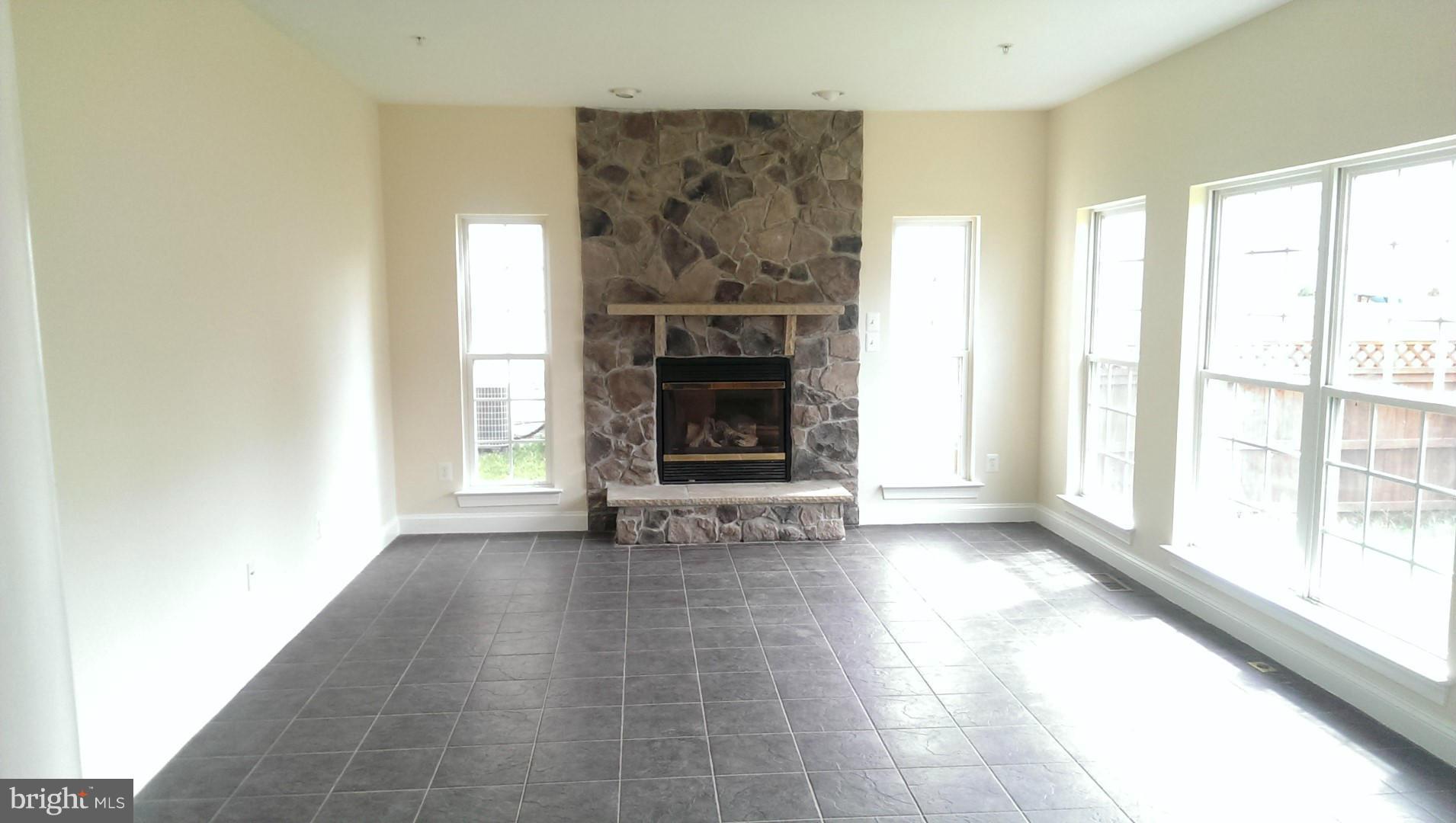 2105 Medinah Ridge Road Accokeek, MD 20607 - Photo 2 of 8 a view of a livingroom with a fireplace and window