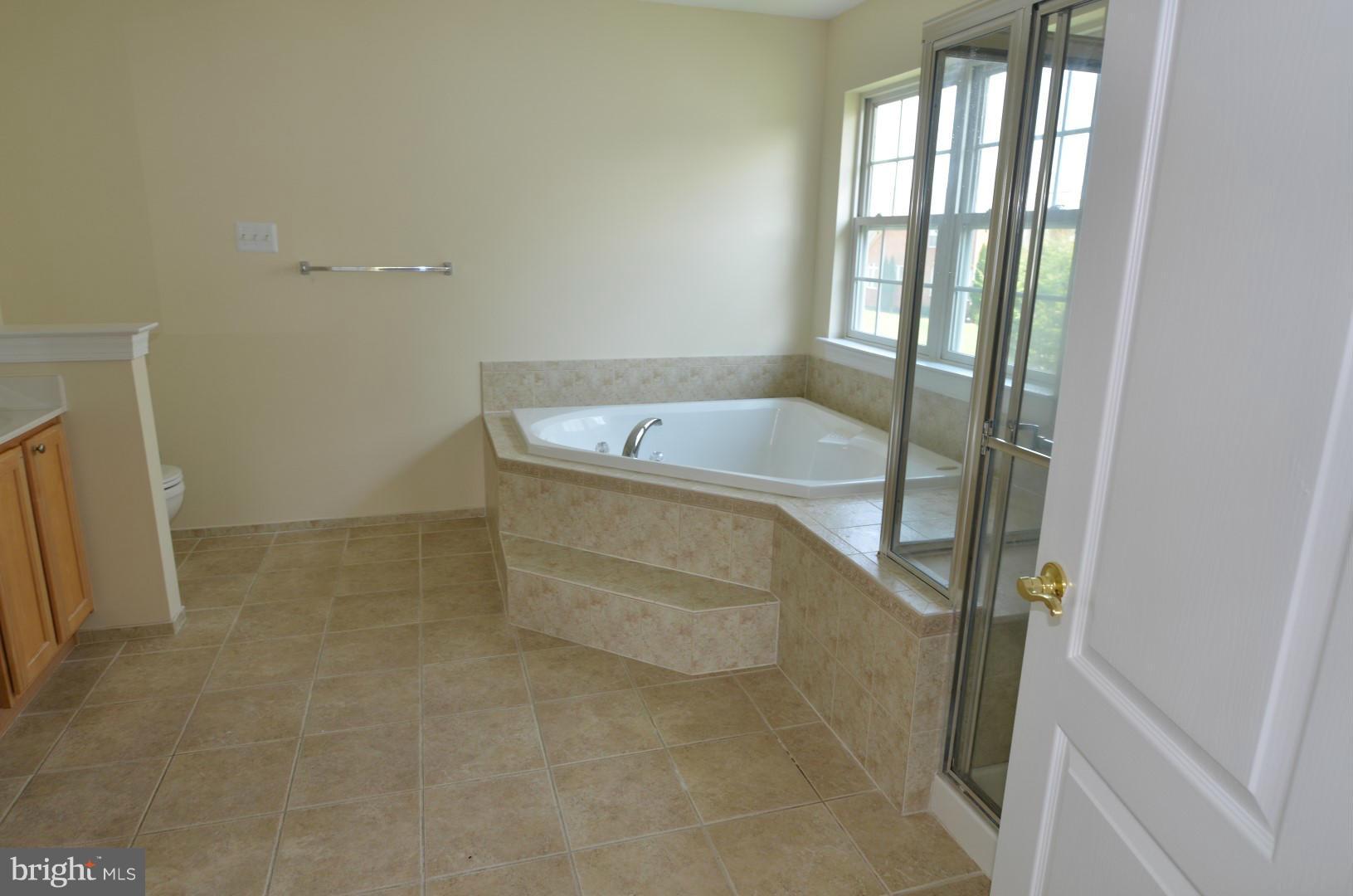2105 Medinah Ridge Road Accokeek, MD 20607 - Photo 6 of 8 a bathroom with a tub and shower