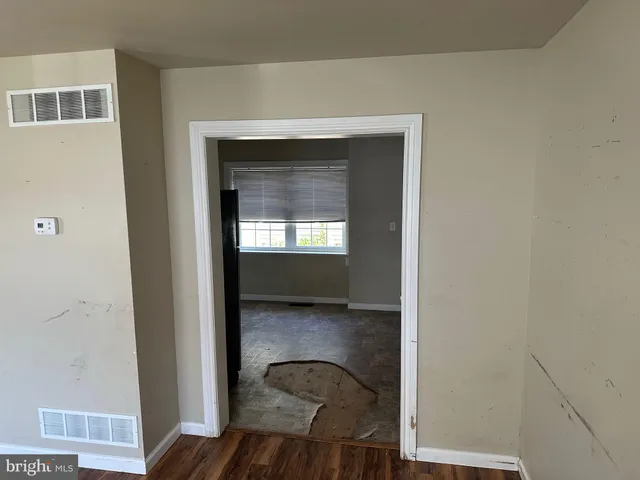 a kitchen with granite countertop white cabinets and refrigerator