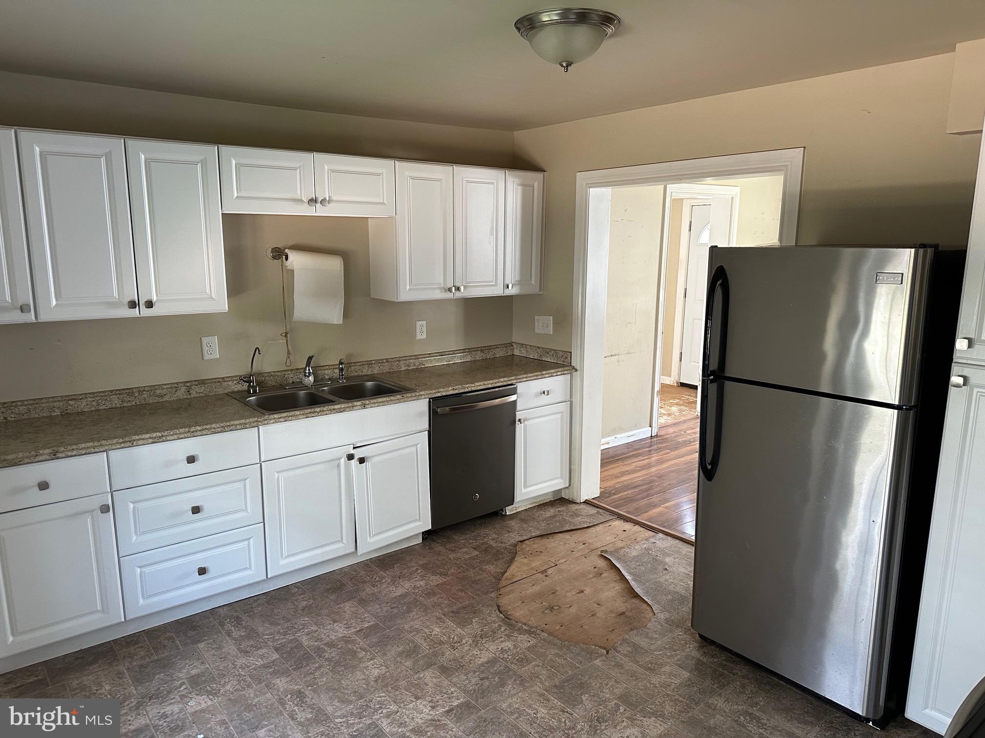192 Limestone Road Oxford, PA 19363 - Photo 7 of 14 a kitchen with granite countertop white cabinets and refrigerator