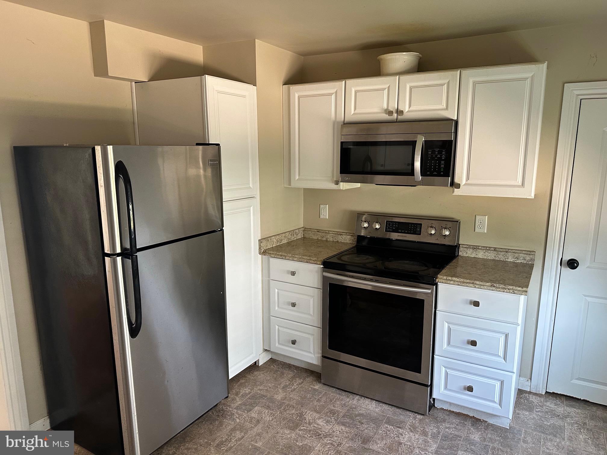 192 Limestone Road Oxford, PA 19363 - Photo 8 of 14 a kitchen with stainless steel appliances a refrigerator stove and microwave