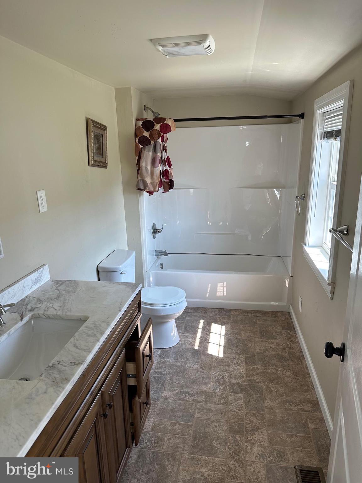 192 Limestone Road Oxford, PA 19363 - Photo 9 of 14 a bathroom with a granite countertop sink a toilet a tub and shower