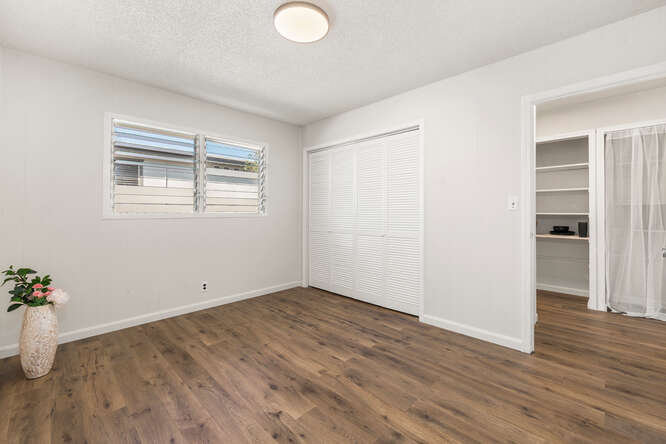 75-164 Lunapule Road Kailua-Kona, HI 96740 - Photo 13 of 27 an empty room with wooden floor and windows