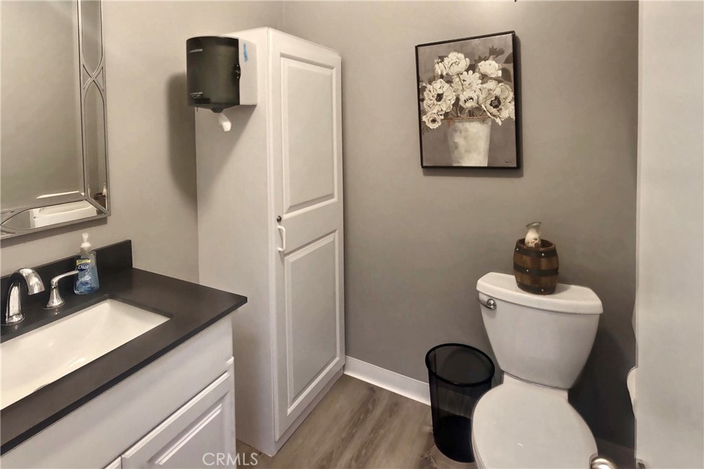 4140 Warner Boulevard, Unit 310 Burbank, CA 91505 - Photo 11 of 18 a bathroom with a toilet sink and mirror
