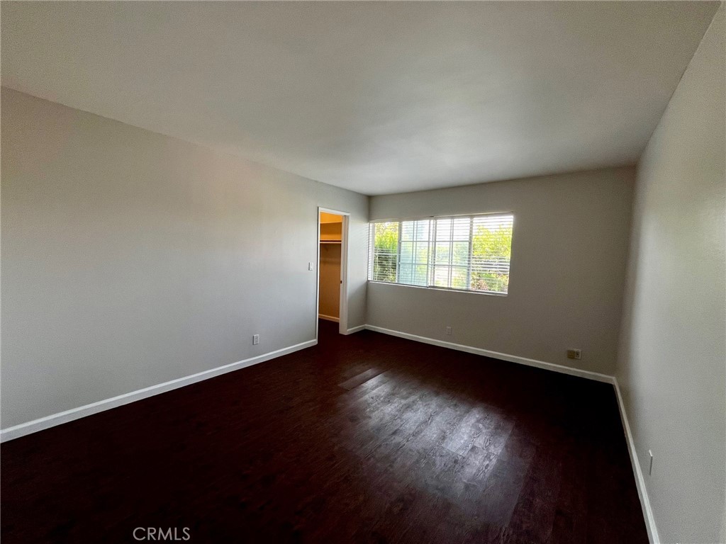 4140 Warner Boulevard, Unit 310 Burbank, CA 91505 - Photo 16 of 18 an empty room with wooden floor and windows