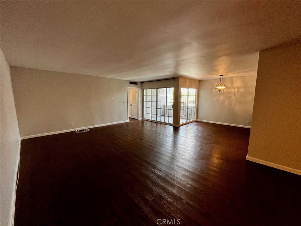 4140 Warner Boulevard, Unit 310 Burbank, CA 91505 - Photo 3 of 18 a view of an empty room with wooden floor and a window