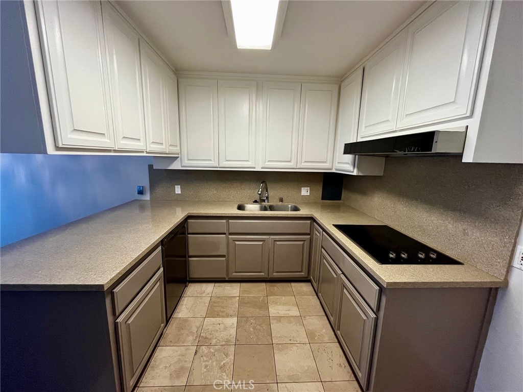 4140 Warner Boulevard, Unit 310 Burbank, CA 91505 - Photo 5 of 18 a kitchen with granite countertop a sink a stove and cabinets