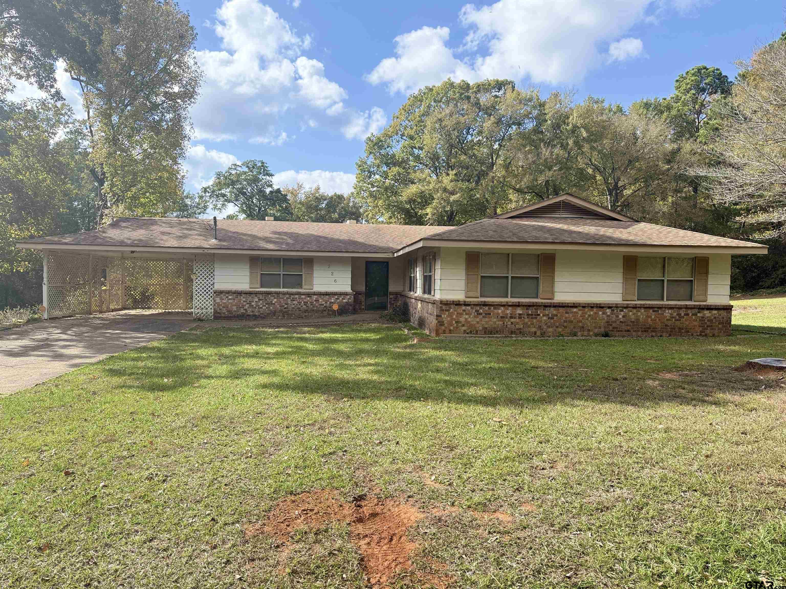 226 Caroline Street Rusk, TX 75785 - Photo 11 of 21 a front view of a house with a yard table and chairs