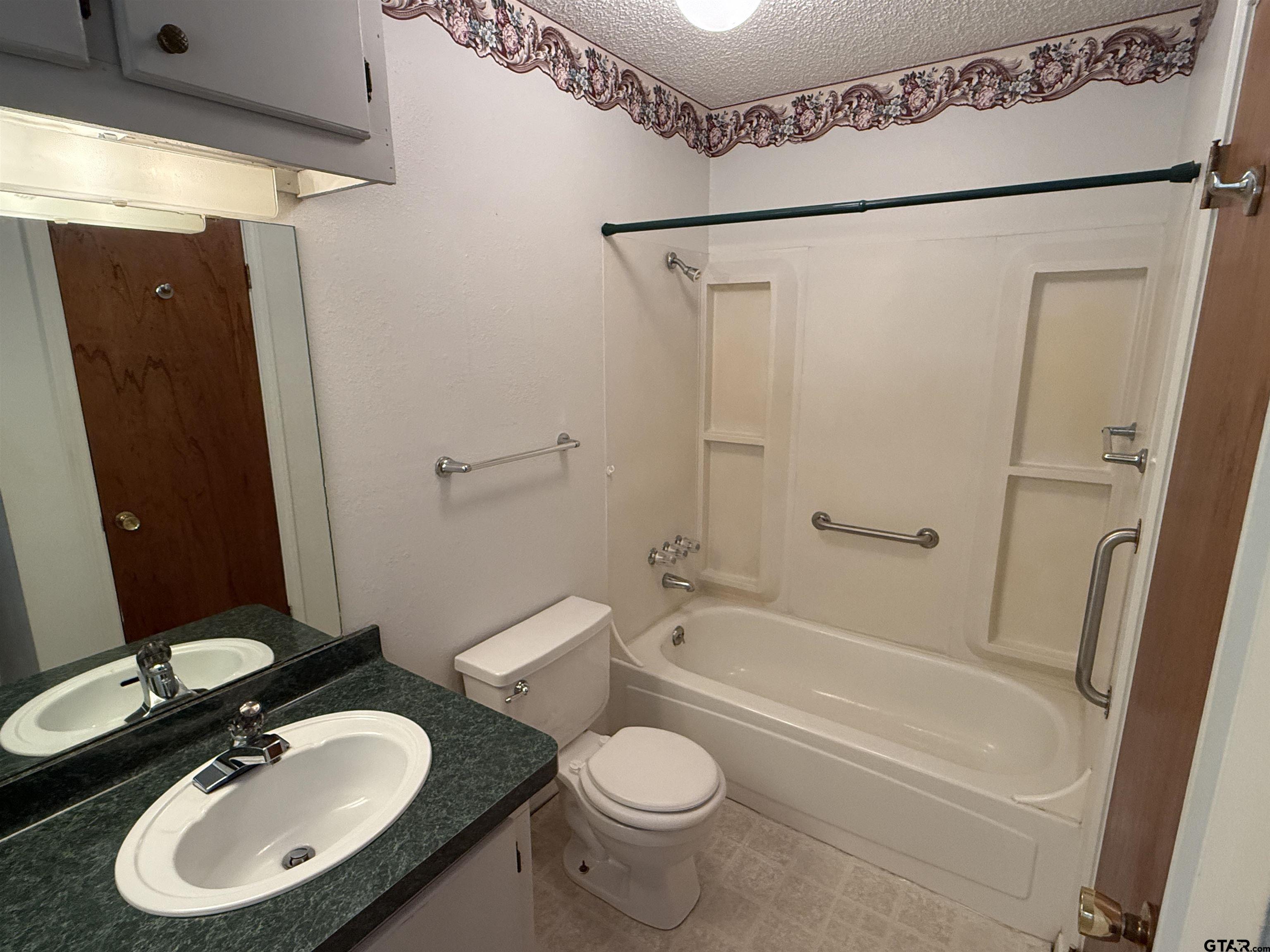 226 Caroline Street Rusk, TX 75785 - Photo 13 of 21 a bathroom with a sink toilet and shower