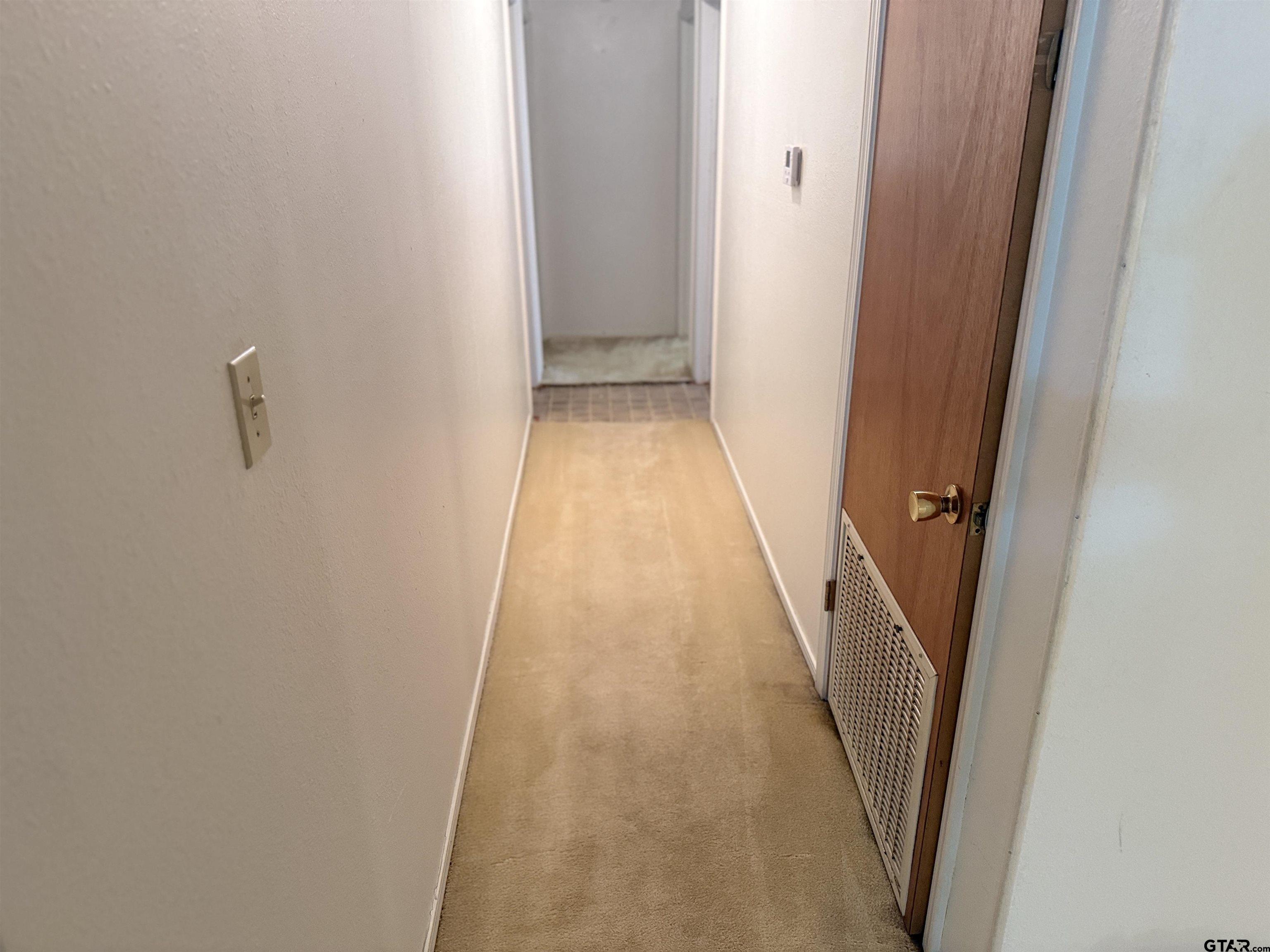 226 Caroline Street Rusk, TX 75785 - Photo 14 of 21 a view of a hallway with wooden floor and a door