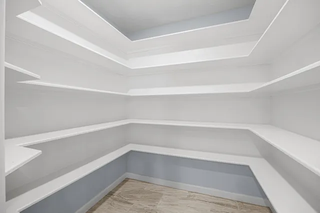 a kitchen with granite countertop white cabinets and white stainless steel appliances