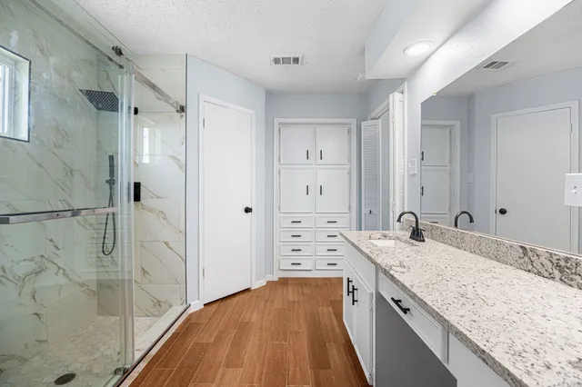 a bathroom with a glass shower door