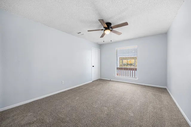 an view of an empty room with a window