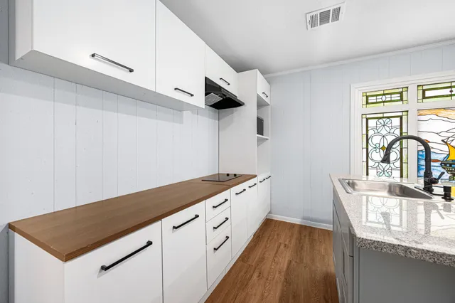 a view of a kitchen with a sink and a window