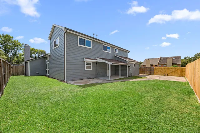 a view of house with backyard