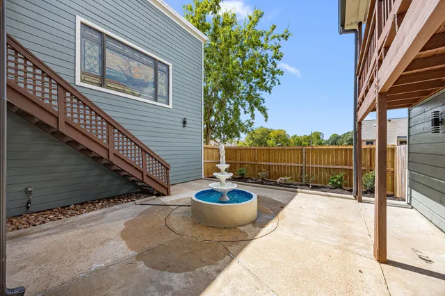 a view of a balcony with two chairs and a potted plant