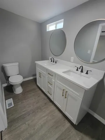 a bathroom with a double vanity sink mirror and shower