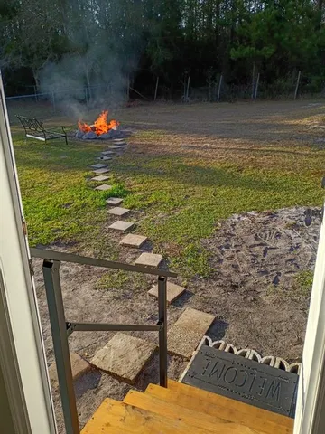 a kitchen with stainless steel appliances a sink a stove a refrigerator cabinets and a dining table