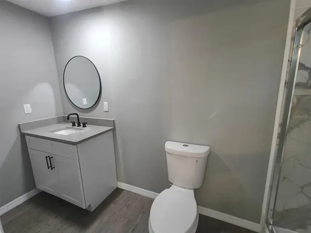 a bathroom with a sink toilet and shower
