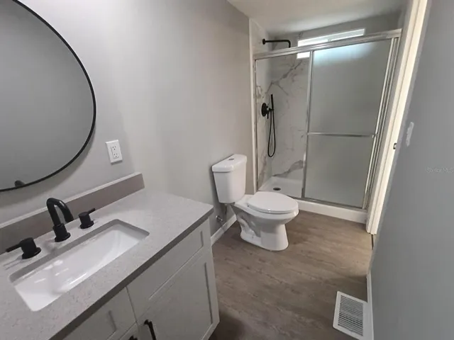 a bathroom with a shower and a bath tub